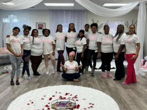 Zina Davis sits on the floor in front of her Mom Circle Group, hosted at Children of the Rising Sun